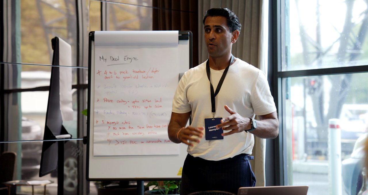 Lawrence working a deal on the board at a member intensive