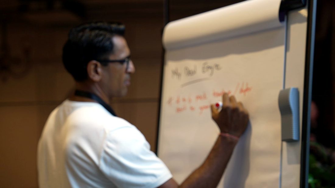 Lawrence teaching deal structure at the front of the room